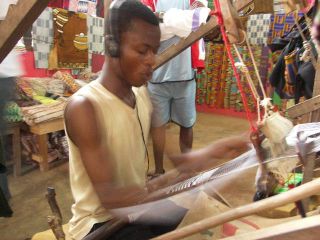 A man weaves kente cloth using a traditional loom in Bonwire (a village) in Ashanti region, Ghana.
