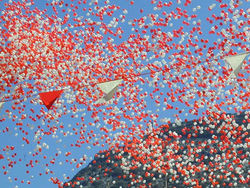 Symbolic release of red and white balloons