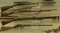 A collection of rifles from the Fram museum, a civilian Krag-Jørgensen M1894 with a carved stock on top.