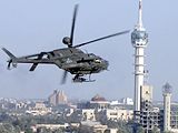 A helicopter flying by Baghdad's tower