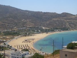 The tourism industry is an important source of income in Greece. Here, the popular Milopotas Beach in the island of Ios.