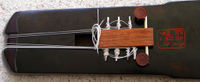 The new tuning device which clips onto the goose-feet and is strung using a tuning wrench on the zither-pins. The pins are adjusted to more-or-less the required pitch, whilst the tuning pegs on the head are used to tune it more finely