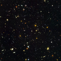 Distant galaxies in deep space in the Hubble Ultra Deep Field photograph.
