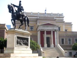 The statue of Theodoros Kolokotronis in Stadiou Street, central Athens. The Old Parliament stands tall behind it.