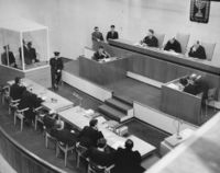 Nazi war criminal Eichmann in a bulletproof glass booth during the open trial in 1961.