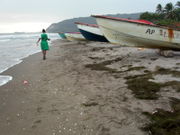 Fishing boats and bauxite cargo ships share the waterways near Alligator Pond, Jamaica