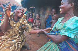 Two women whose lips have been cut off by LRA rebels socialize in Gulu District