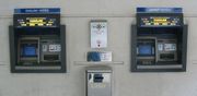 Twin cash machines at a bank in Jersey dispense a choice of Bank of England banknotes or Jersey banknotes