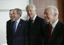 President George W. Bush (second from left), walks with, from left, former President George H.W. Bush, former President Bill Clinton and former President Jimmy Carter during the dedication of the William J. Clinton Presidential Center and Park in Little Rock, Arkansas, November 18, 2004.