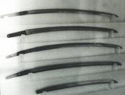 Several katana and wakizashi blades, illustrating the variations in length and curvature. The nakago are well visible.