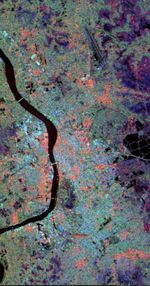 A radar image of Kolkata showing different urban land use patterns. North is to the upper left. Central Kolkata is the light blue and orange area on the right of the river in the center of the image.