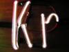 Image of a krypton filled discharge tube shaped like the element's atomic symbol.