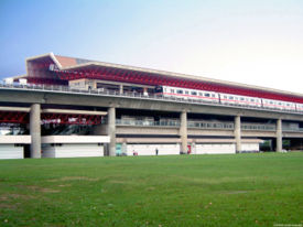 Exterior view of Jurong East MRT Station, showing a C151 train pulling in.