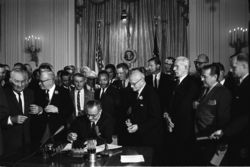 President Johnson signs the historic Civil Rights Act of 1964.