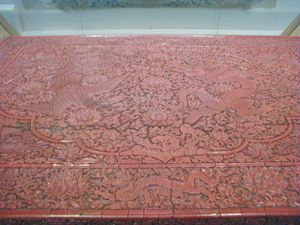 This is the only surviving example in the world of a major piece of lacquer furniture from the "Orchard Factory" (the Imperial Laquer Workshop) set up in Beijing during the early Míng Dynasty. Decorated in dragons and phoenixes it was made to stand in an imperial palace. Made sometime during the Xuande reign period (1426-1435) of the Míng Dynasty. Currently on display at the Victoria and Albert Museum in London.( See the closeup for more detail )