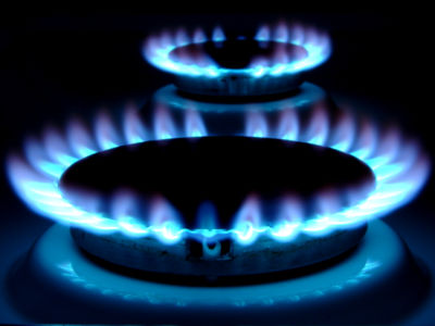Blue flames of a burner on a natural gas stove.