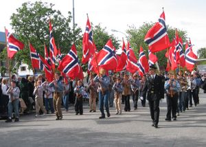 Scouts lead a parade on the 17th of May, Norway's constitution day, holding Norwegian flags